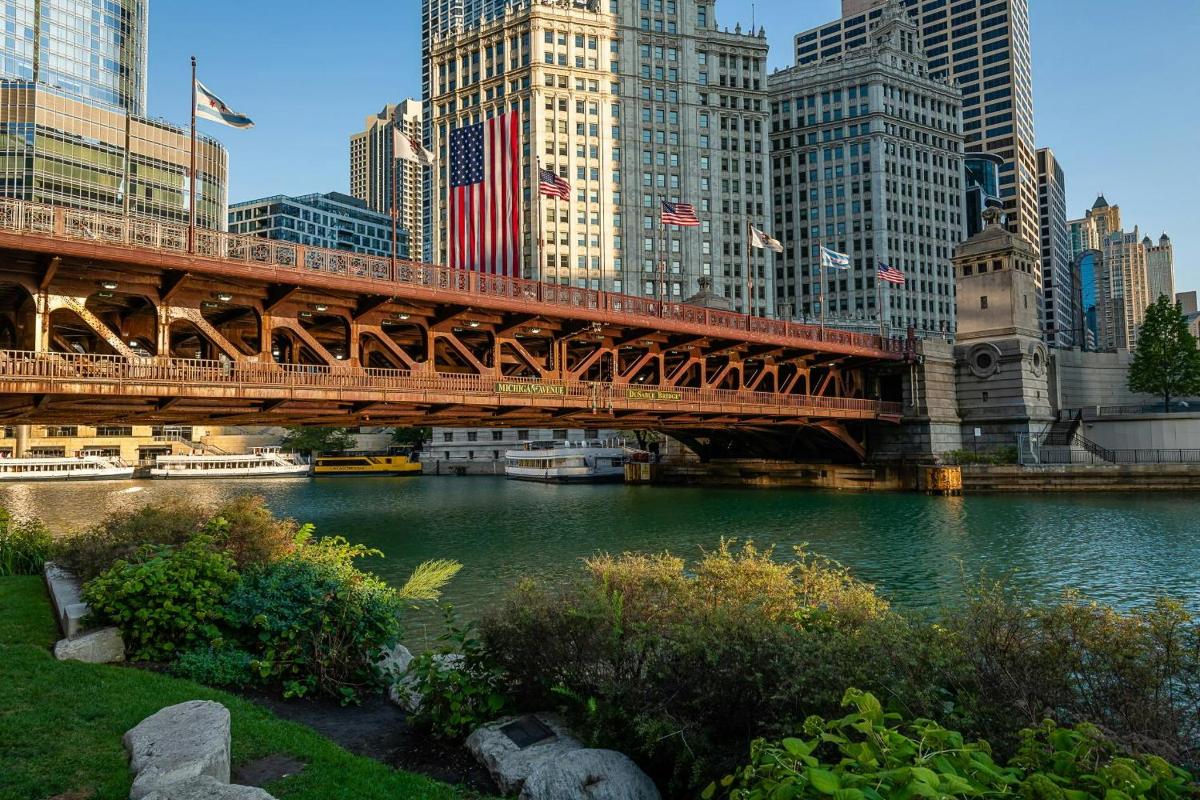 a bridge over a river in a city with tall buildings