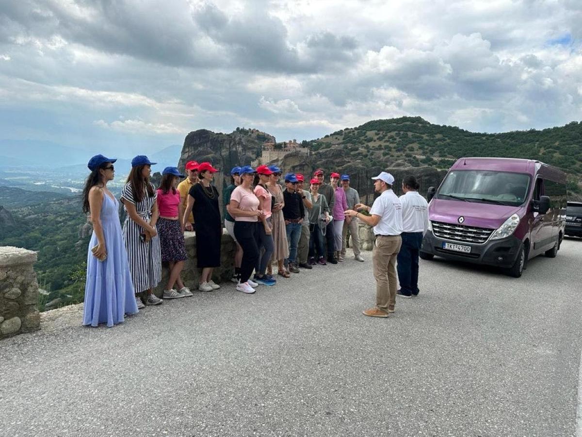 a group of people standing next to a van on a road