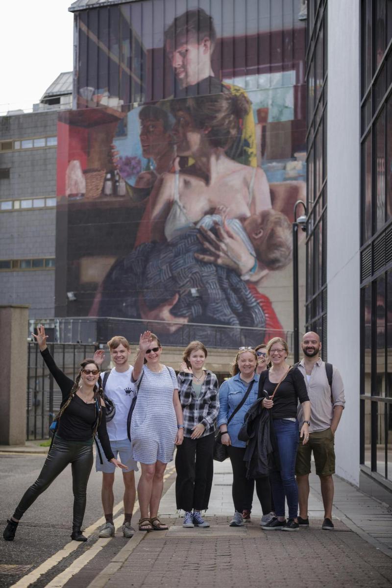 a group of people standing in front of a building