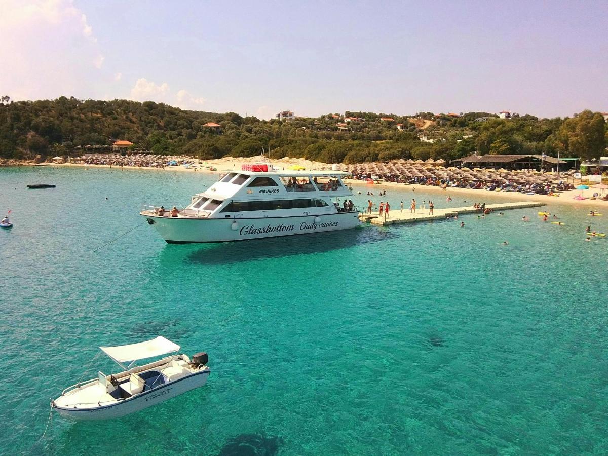 two boats in the water next to a beach
