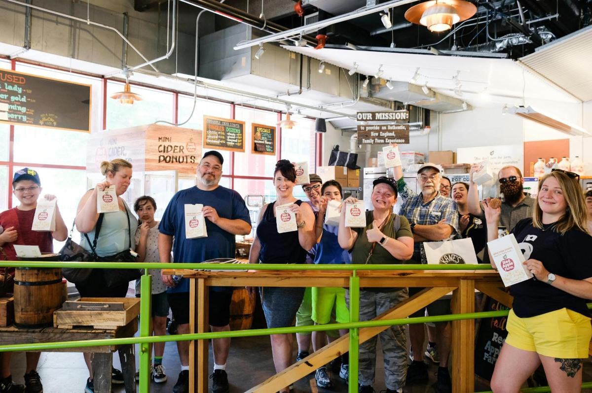 a group of people standing behind a counter holding up signs