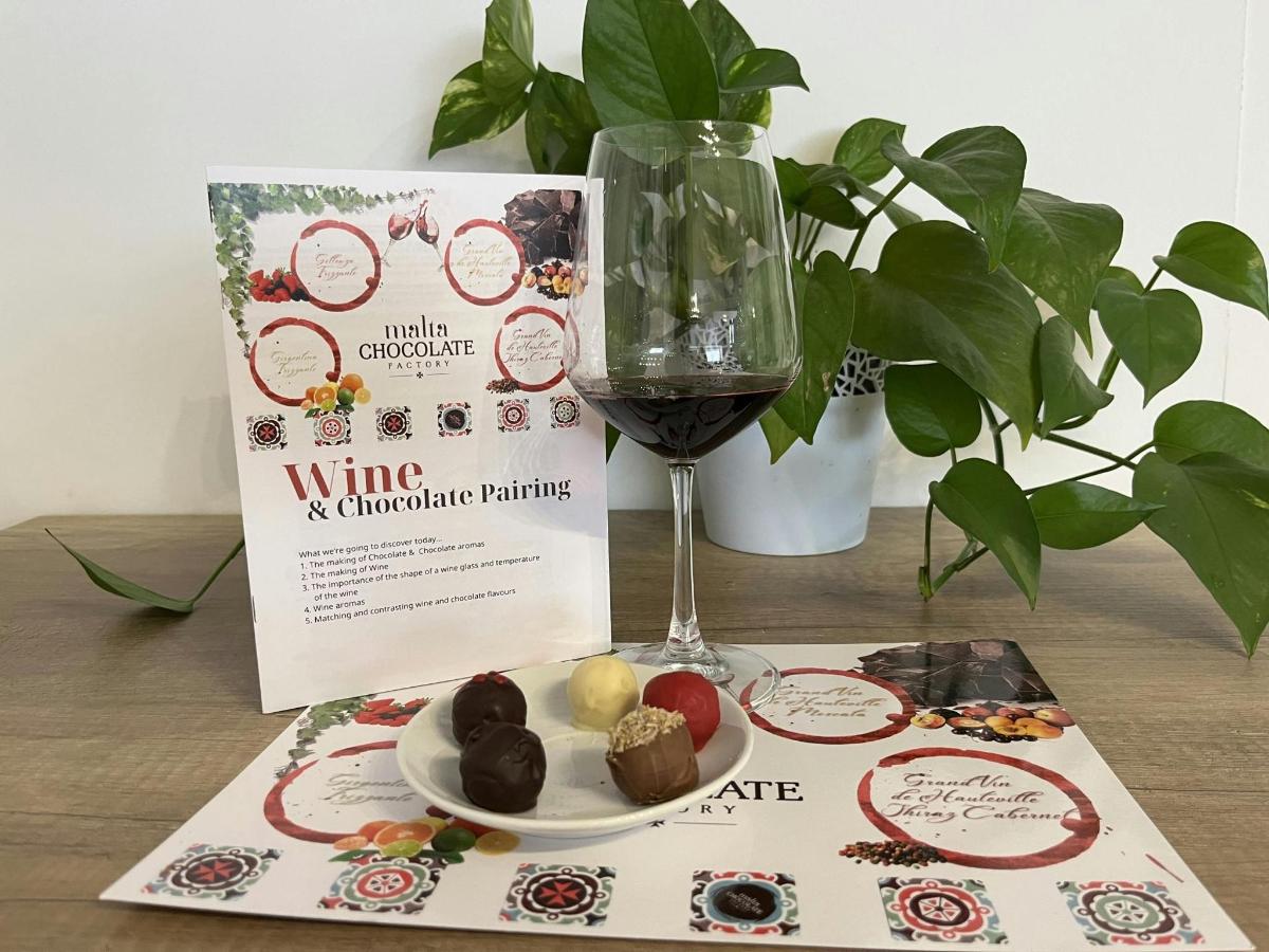 a table with a glass of wine and a plate of food