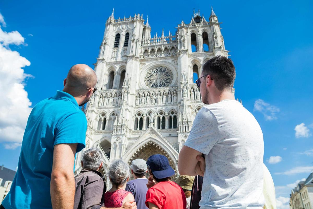 a group of people standing in front of a cathedral