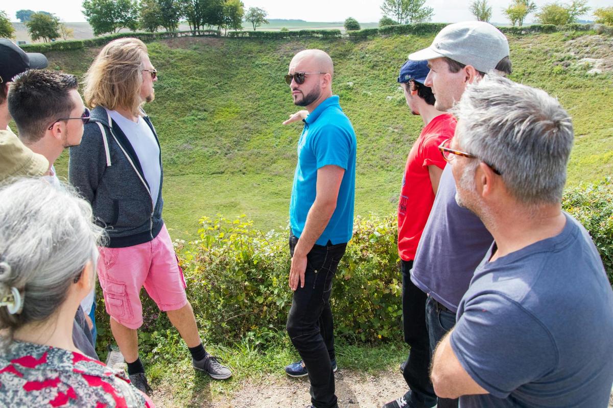 a group of people standing around in a field