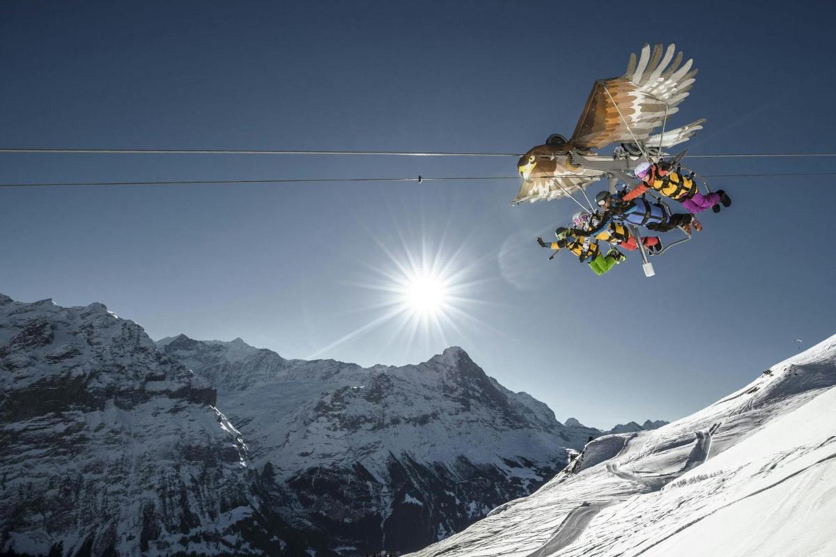 a person doing a flip on a ski lift