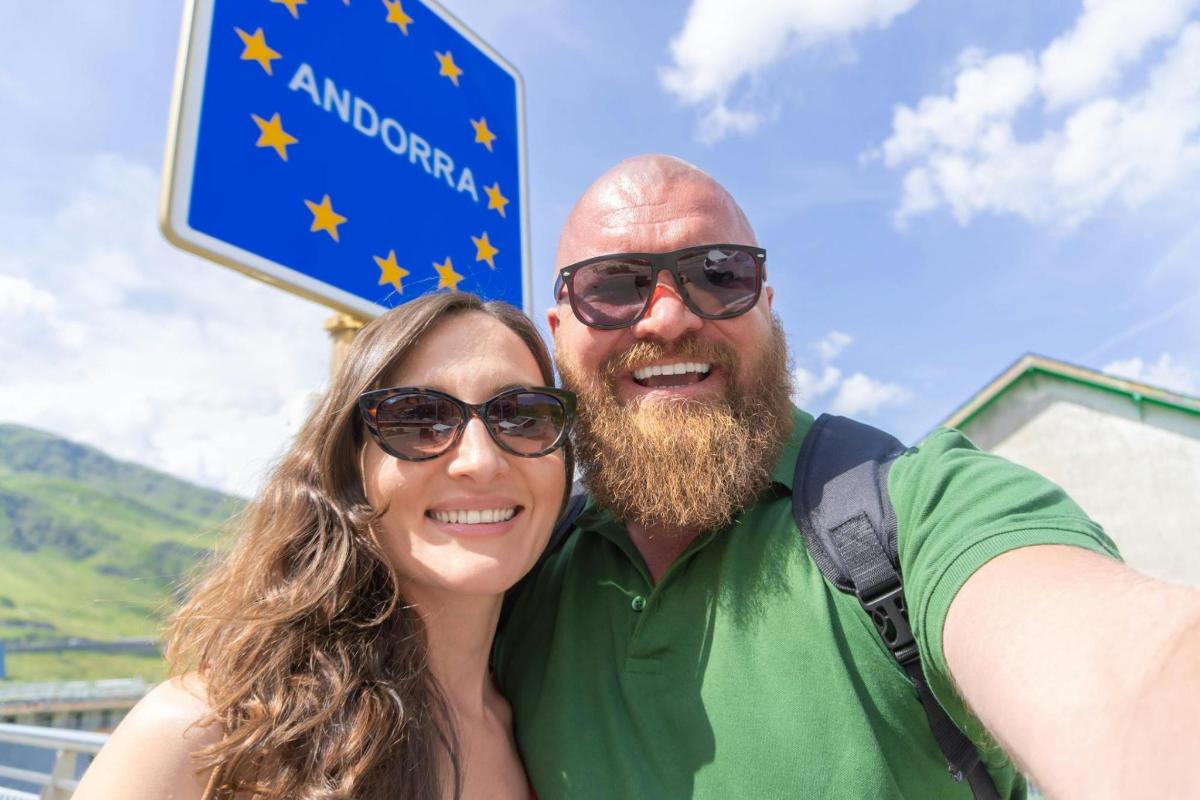 a man and a woman standing next to a sign