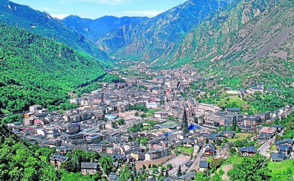 an aerial view of a town in the mountains