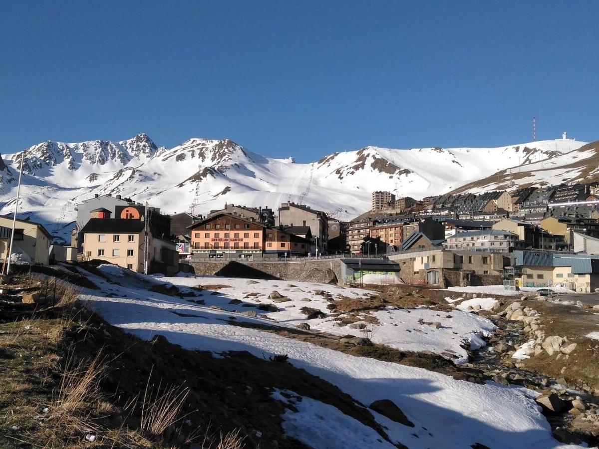 a city with snow covered mountains in the background