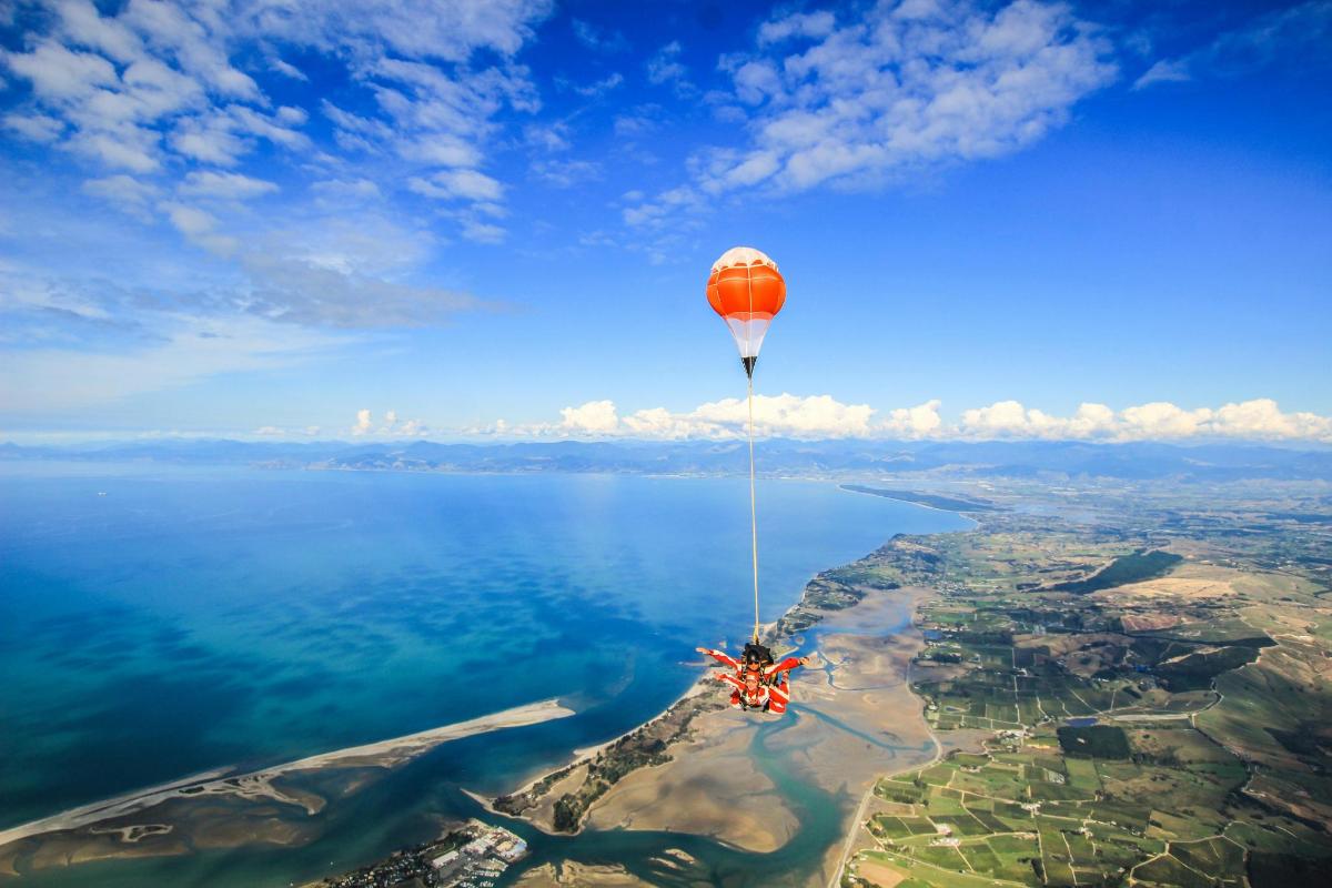 a hot air balloon is flying over the water