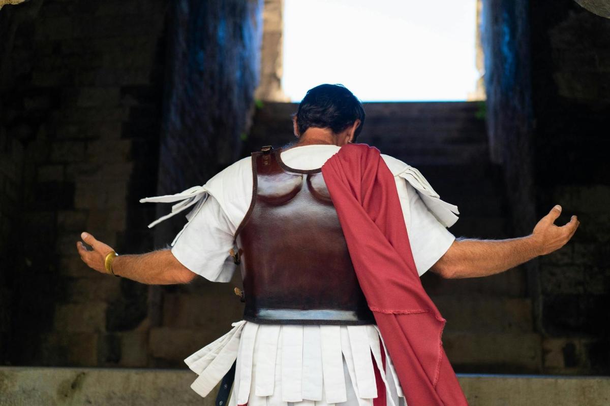 a man in a costume standing with his arms outstretched
