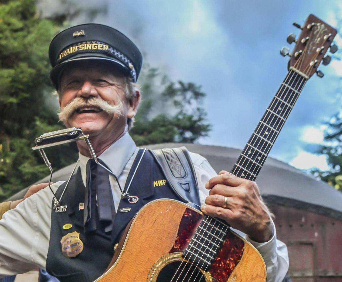 an older man in uniform playing a guitar