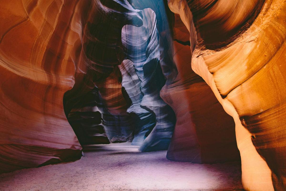 a person is standing in a slot canyon