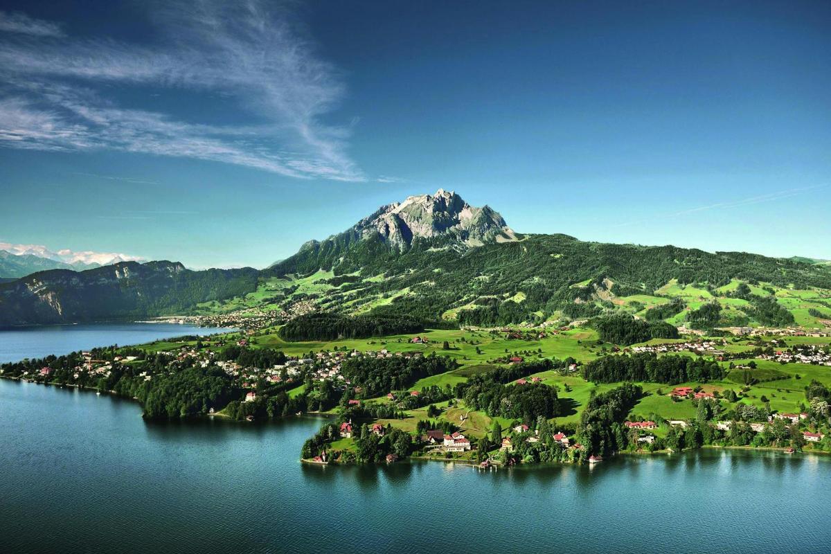 an island in a body of water with a mountain