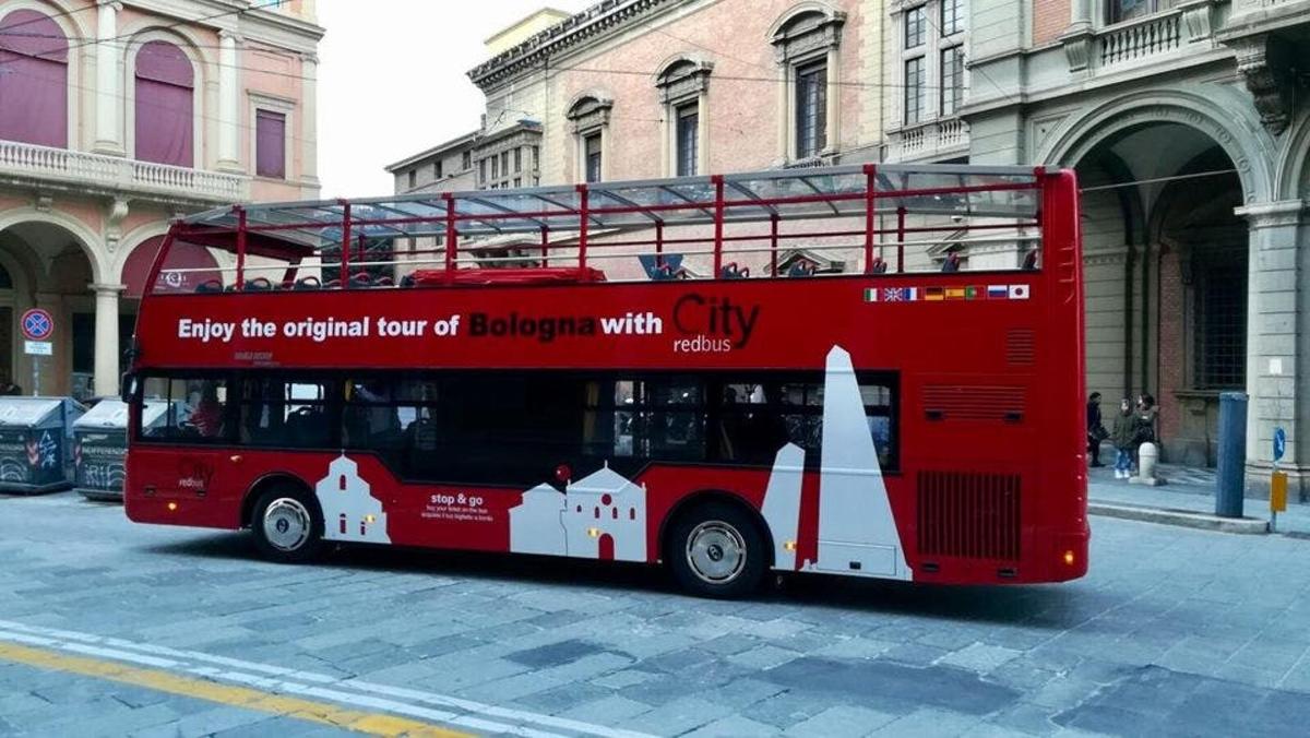 a red double decker bus on a city street