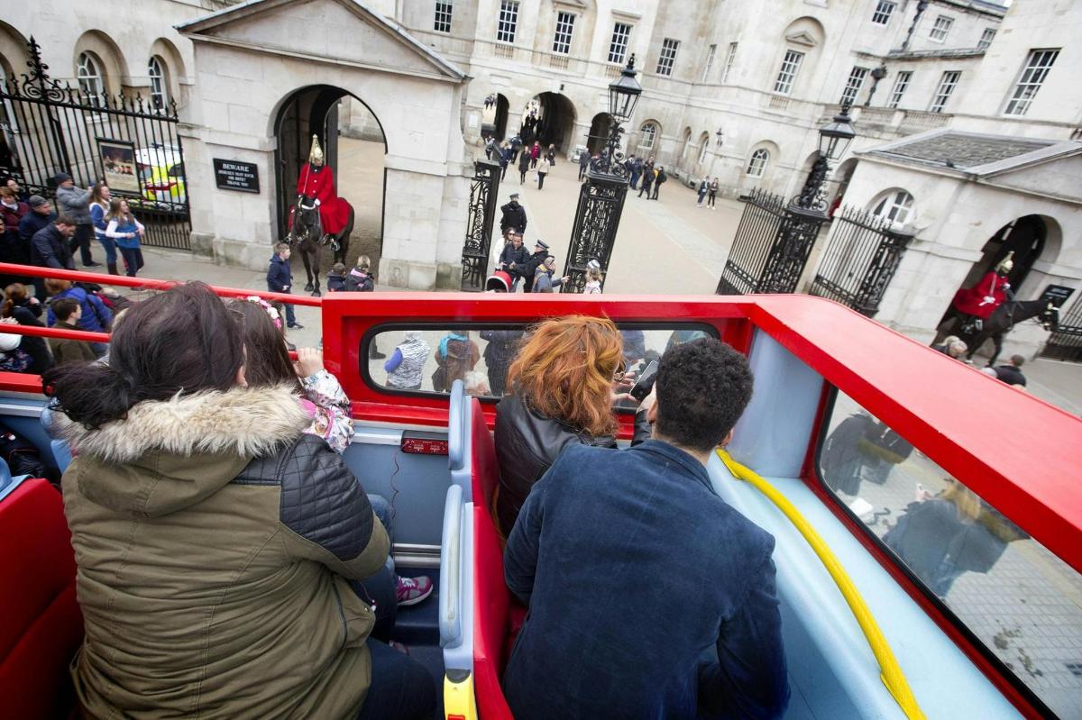 a group of people riding on a double decker bus