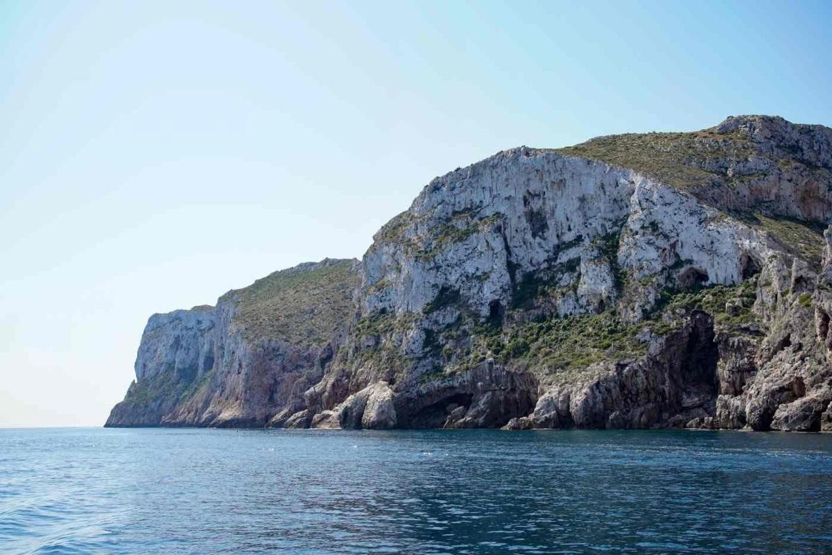 a rocky island in the middle of the water