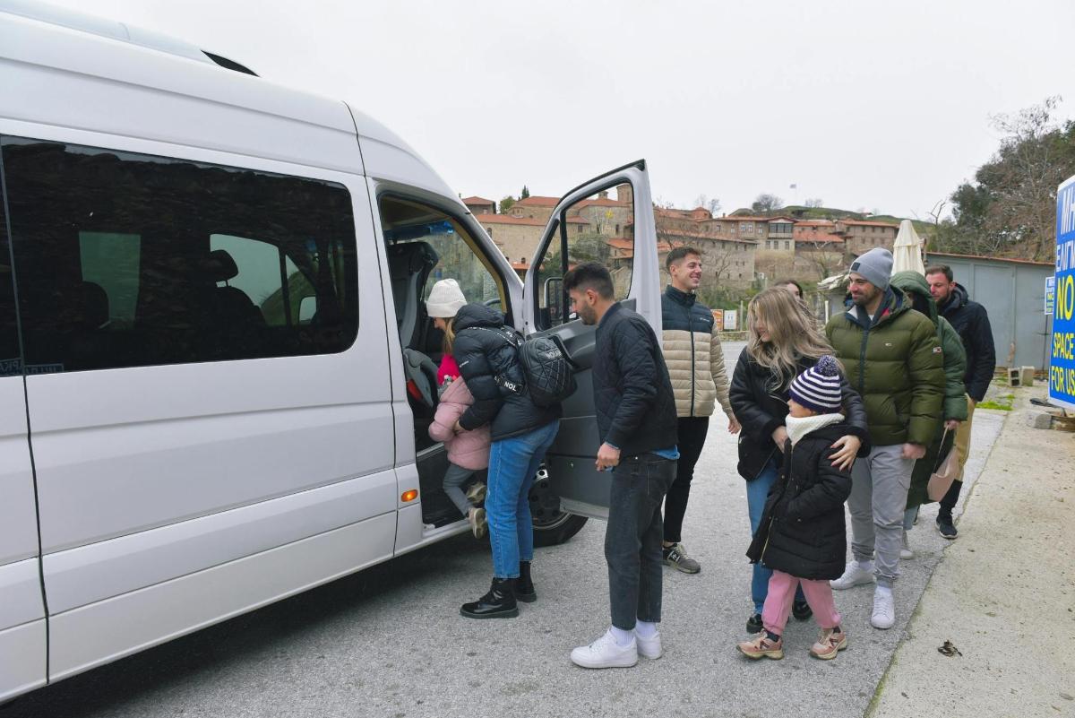a group of people getting out of a white van