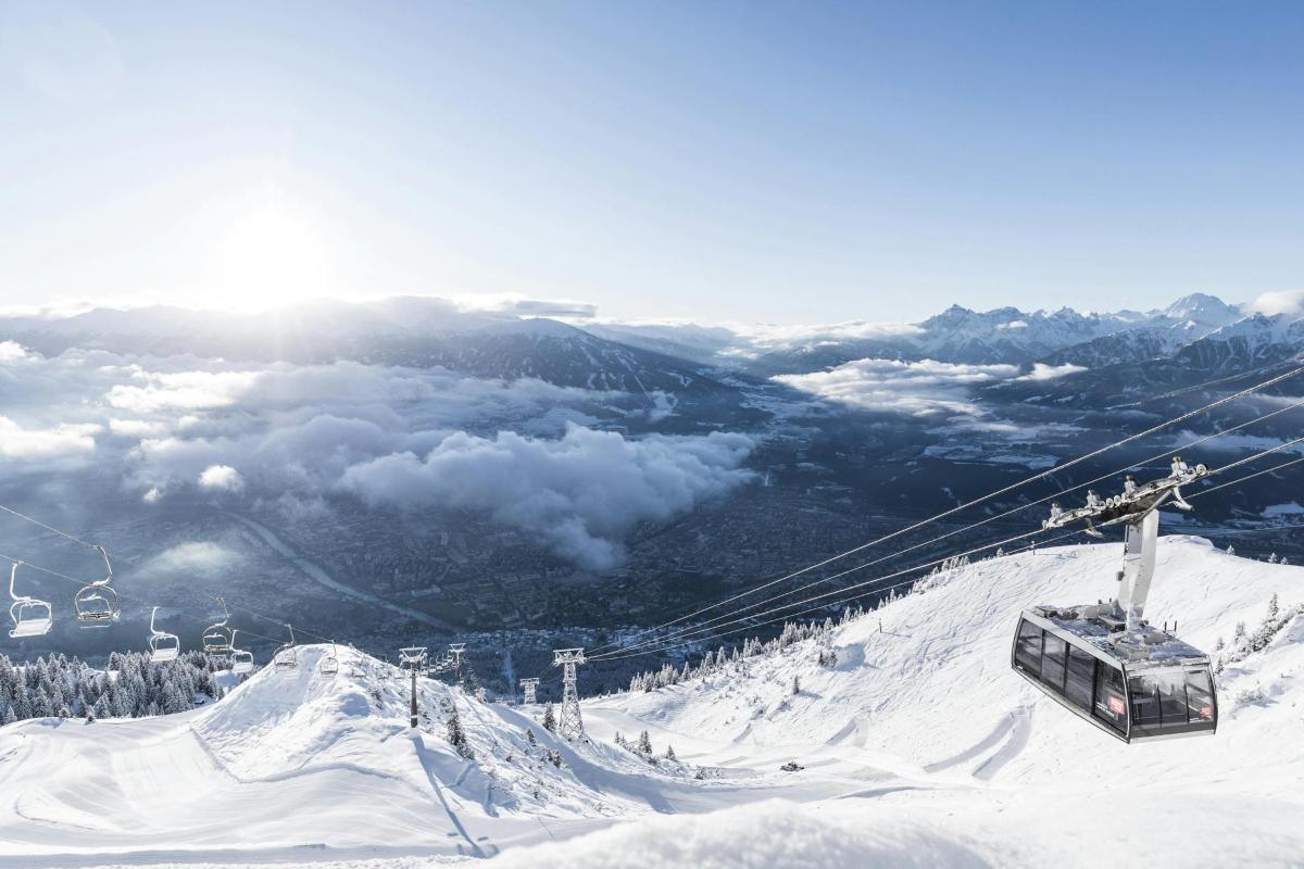 a ski lift on top of a snow covered mountain