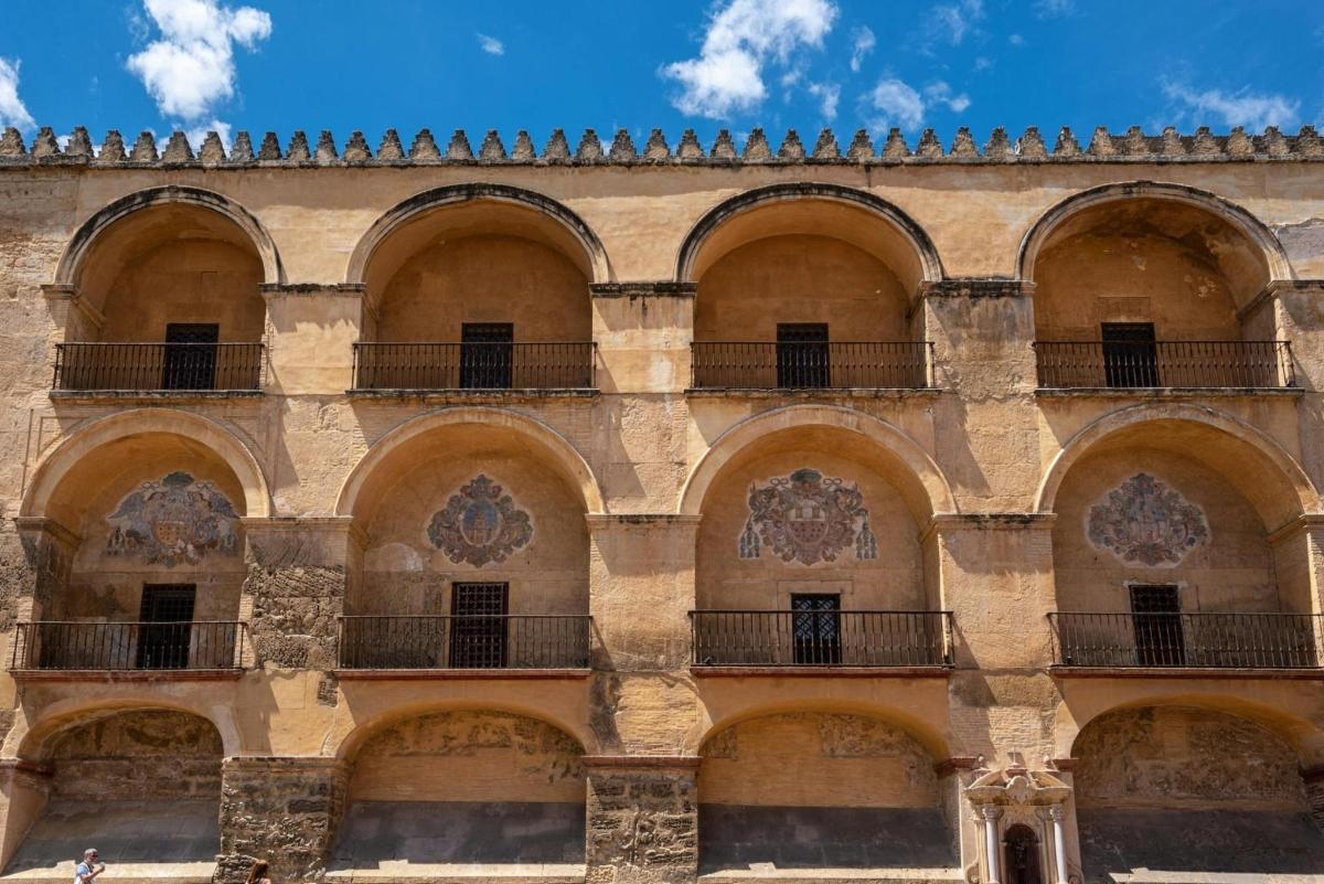 an old building with balconies and a blue sky