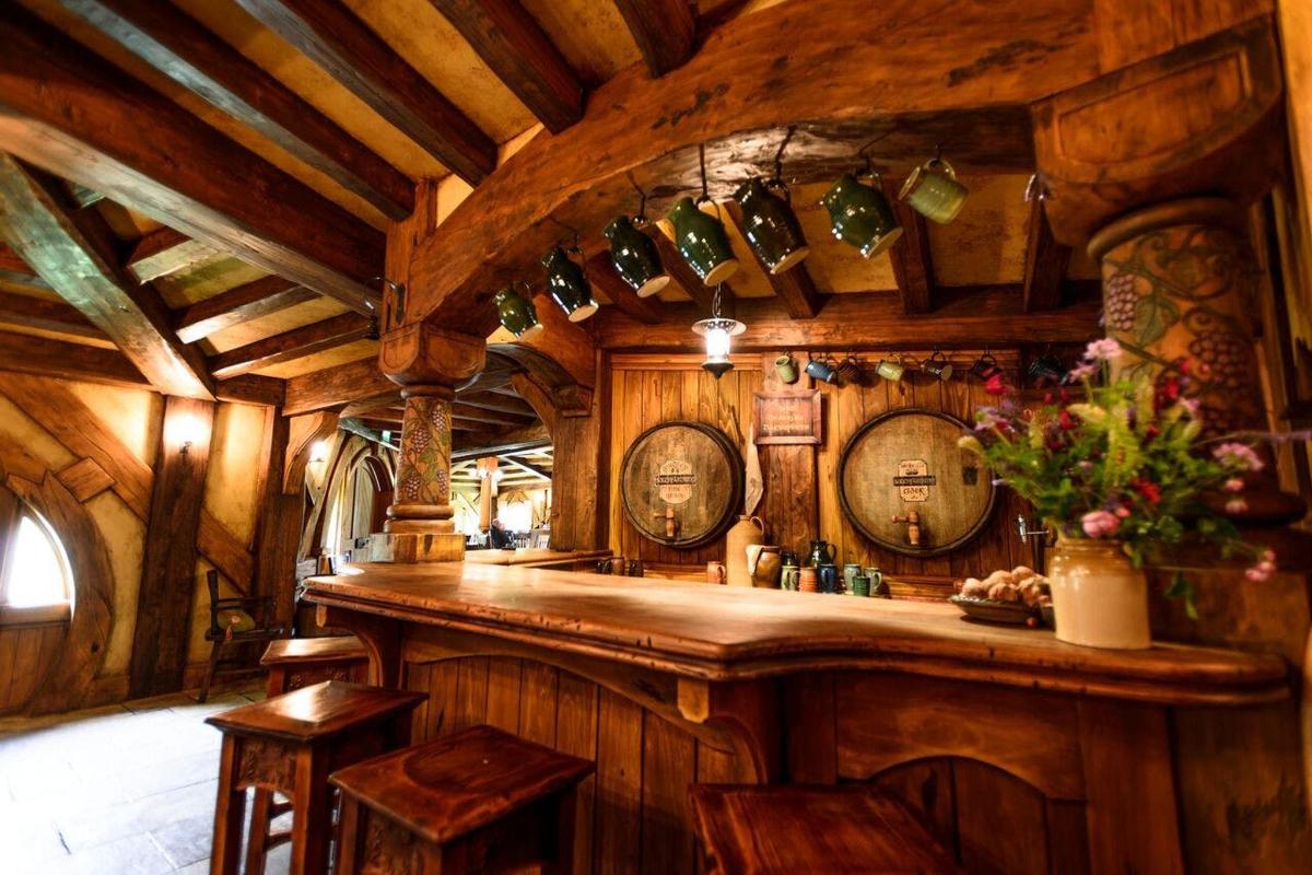 a kitchen with a bar in a room with wooden walls