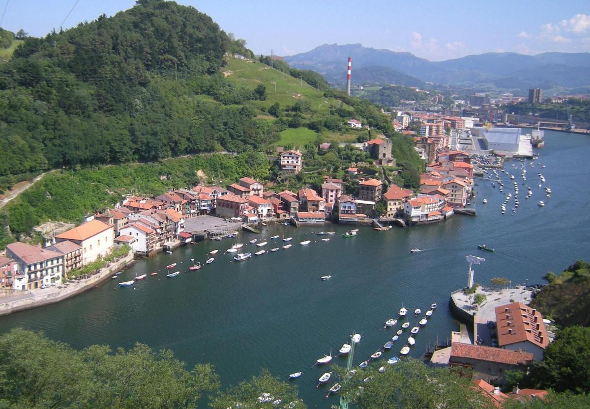a city with boats in a river with a town
