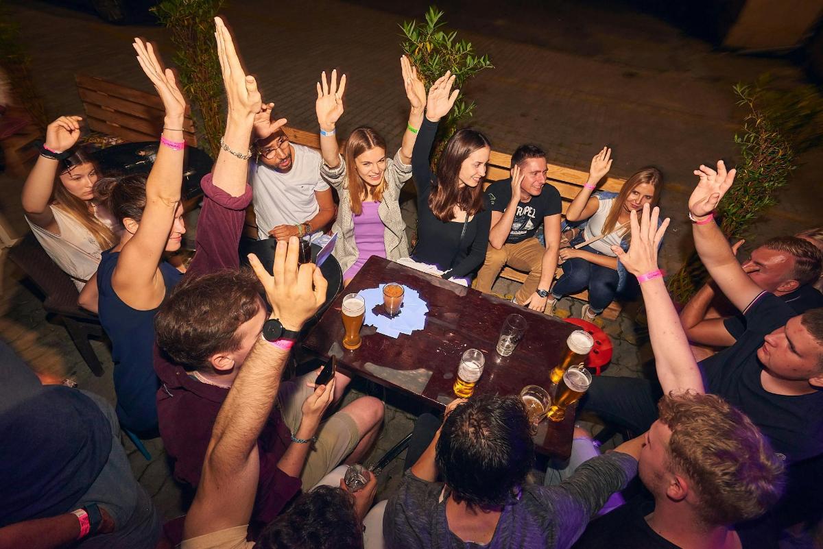 a group of people with their hands in the air