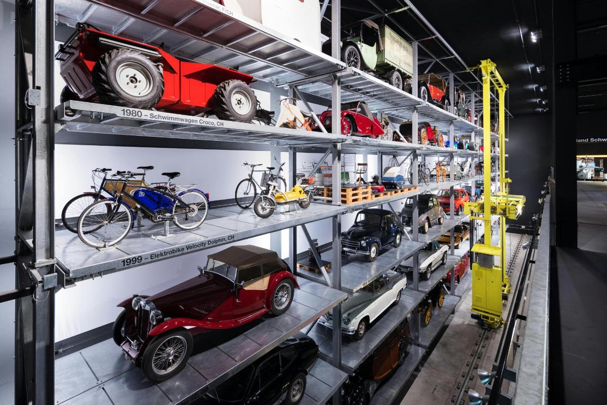 a room with shelves filled with cars and bikes