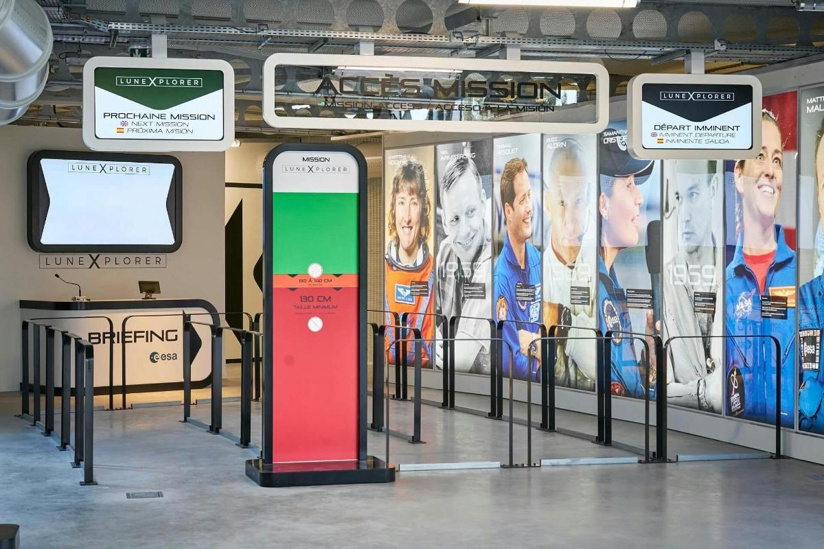 a train station with a display with a cell phone