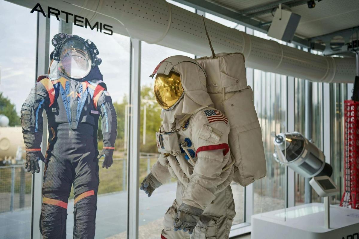 two people in astronaut suits in a window
