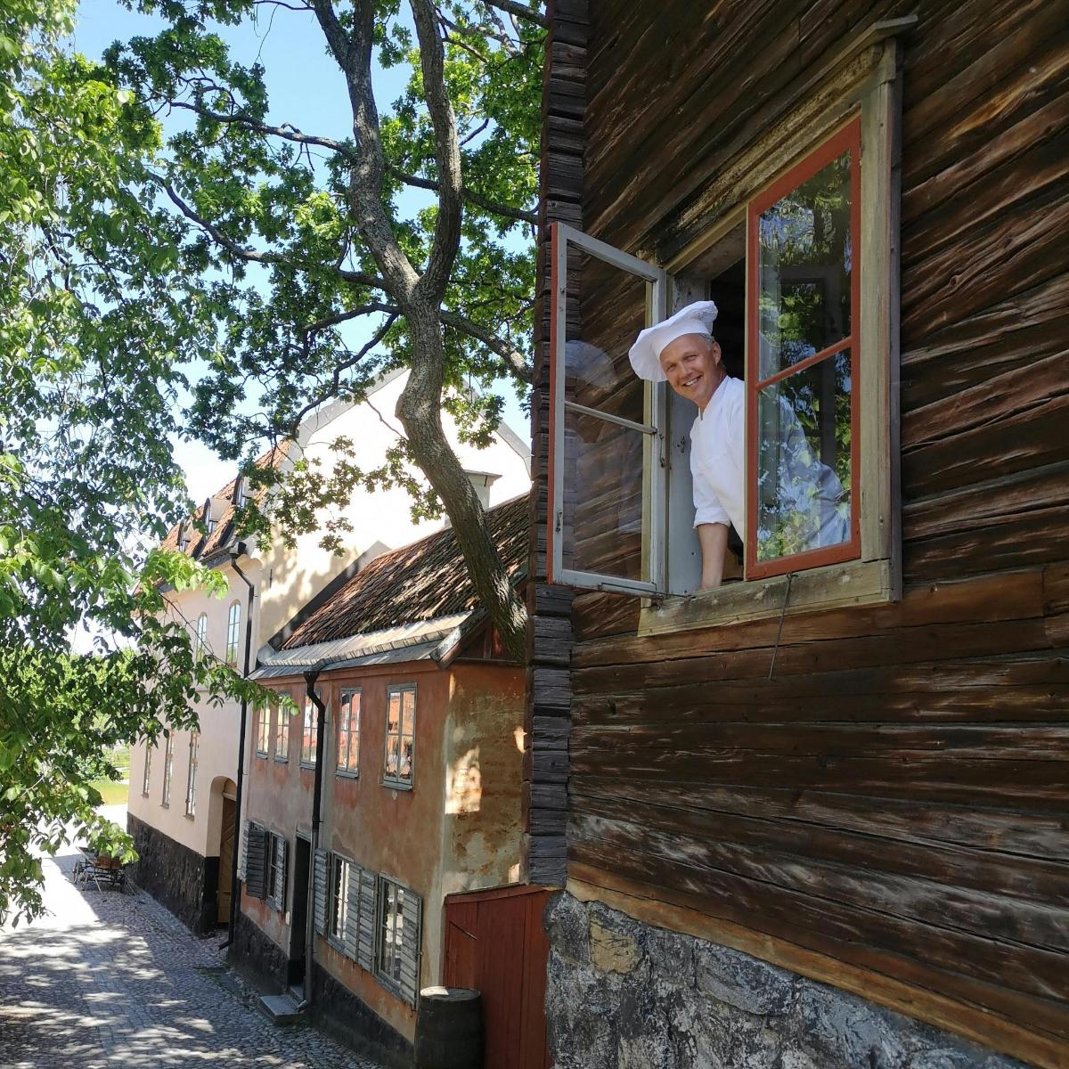 a woman looking out of a window of a house