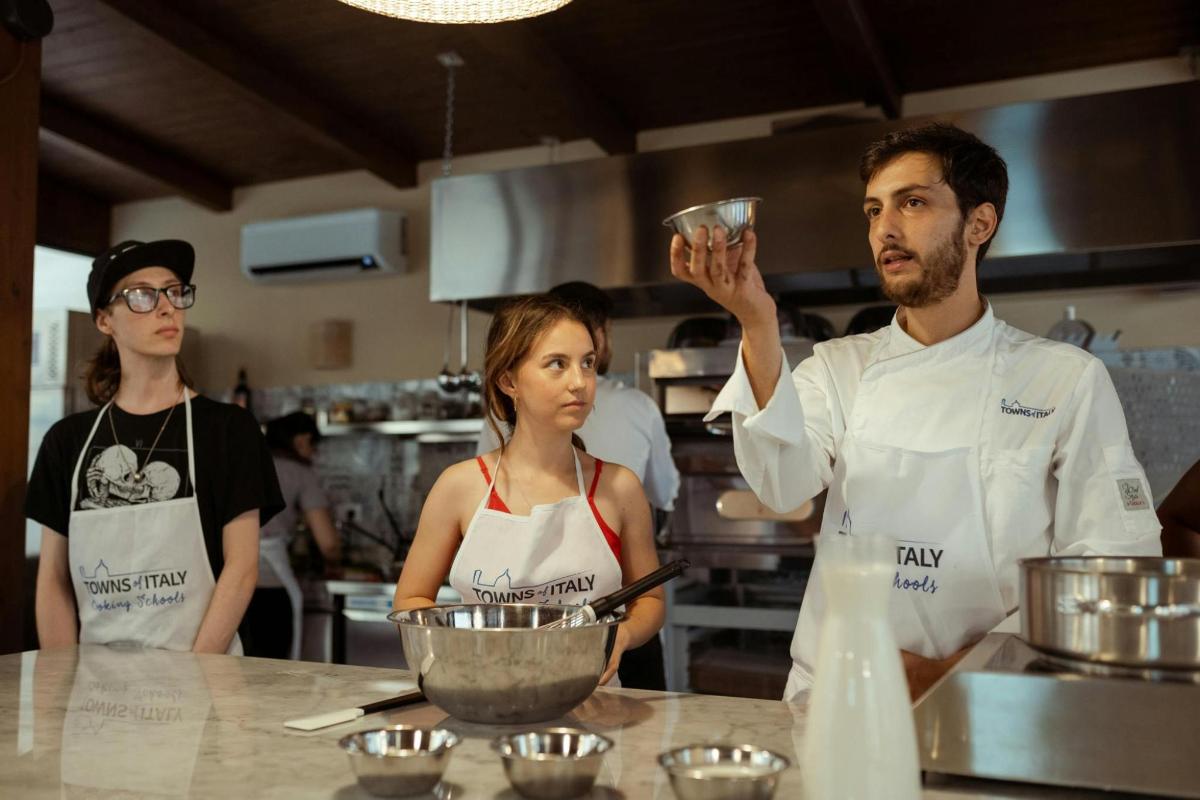 a group of three chefs standing in a kitchen