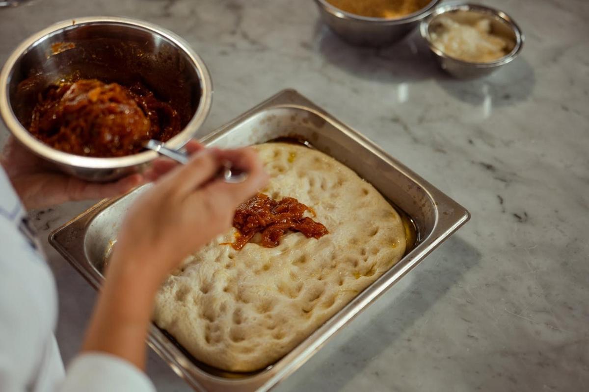 a person is preparing food in a pan