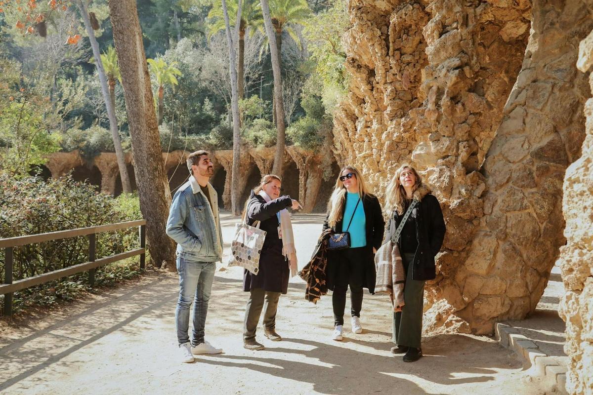 a group of people standing next to a rock wall