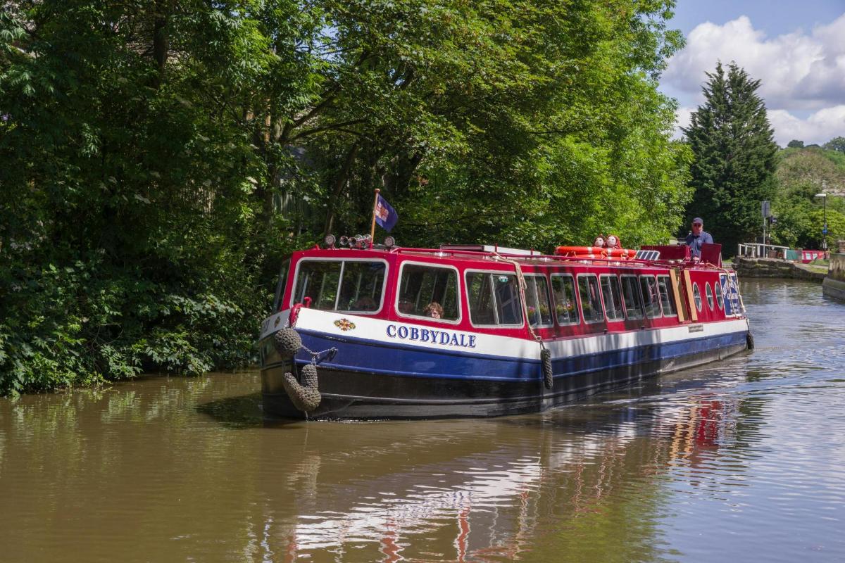 a red and white boat traveling down a river