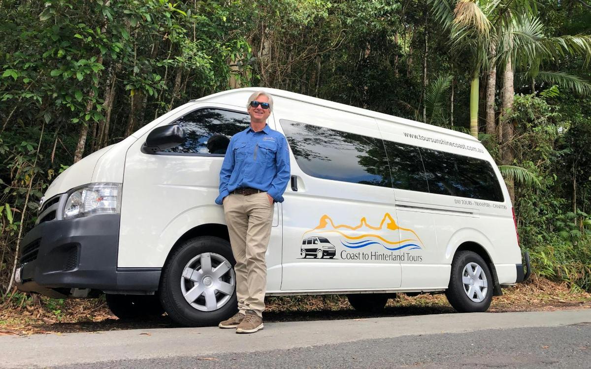a man standing in front of a white van