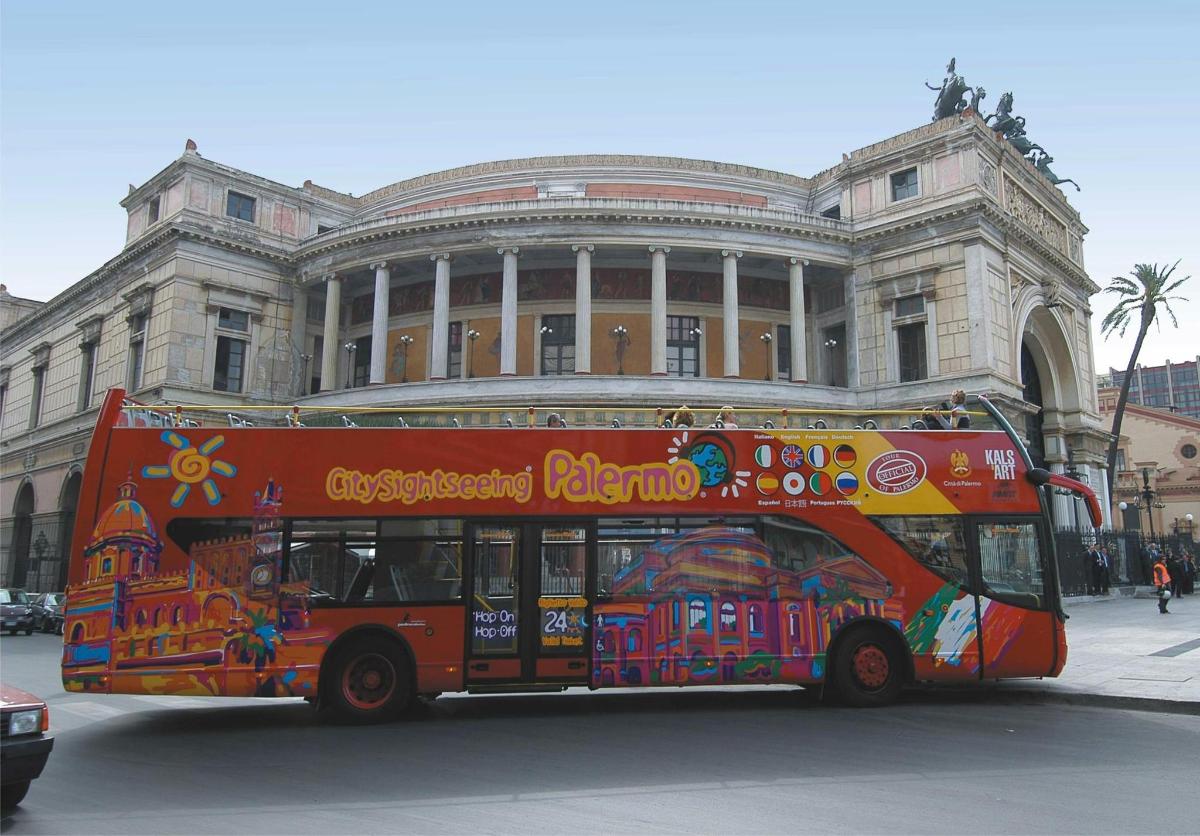 a red bus parked in front of a building