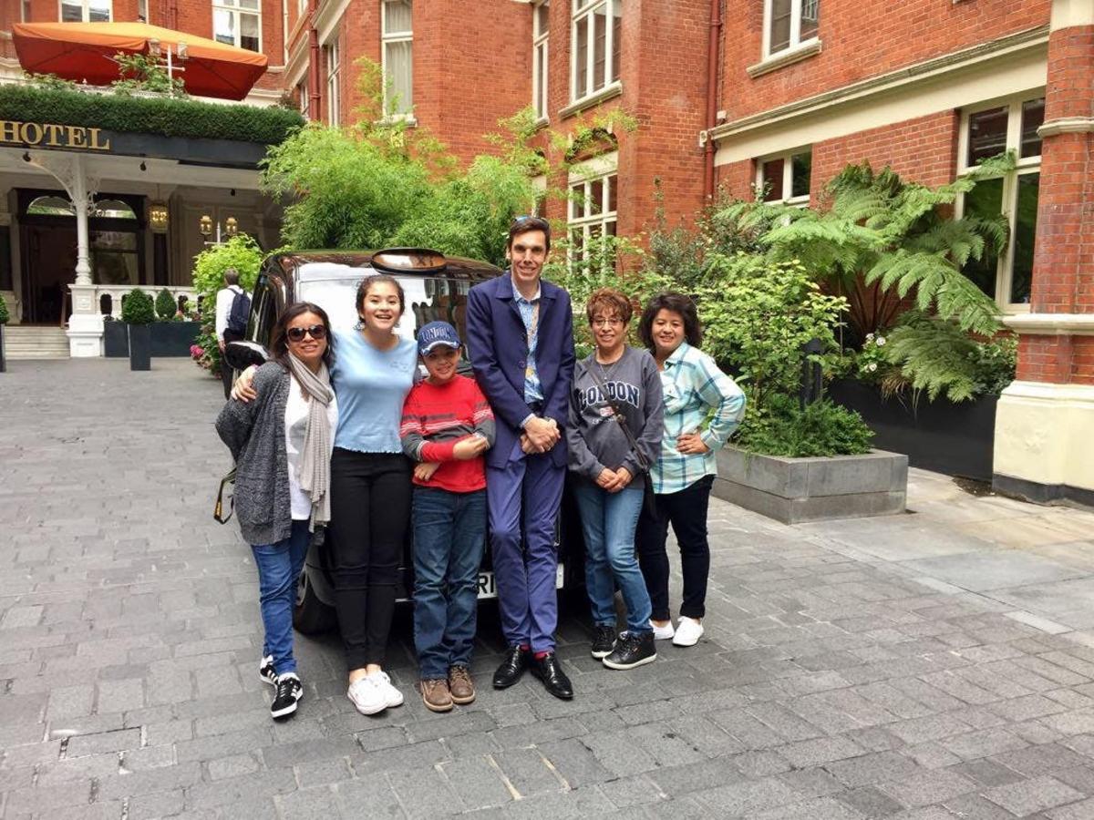 a group of people standing in front of a vehicle