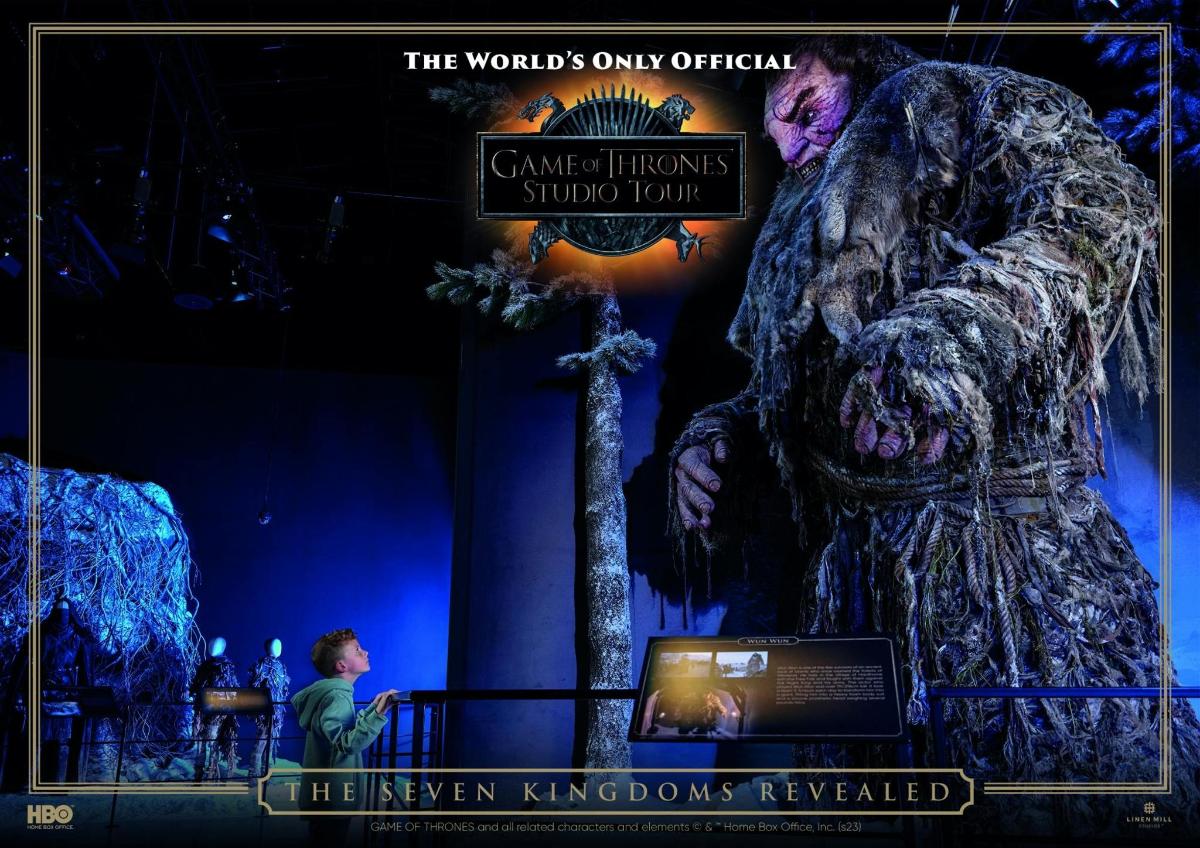 a man standing in front of a statue of a gorilla on a stage