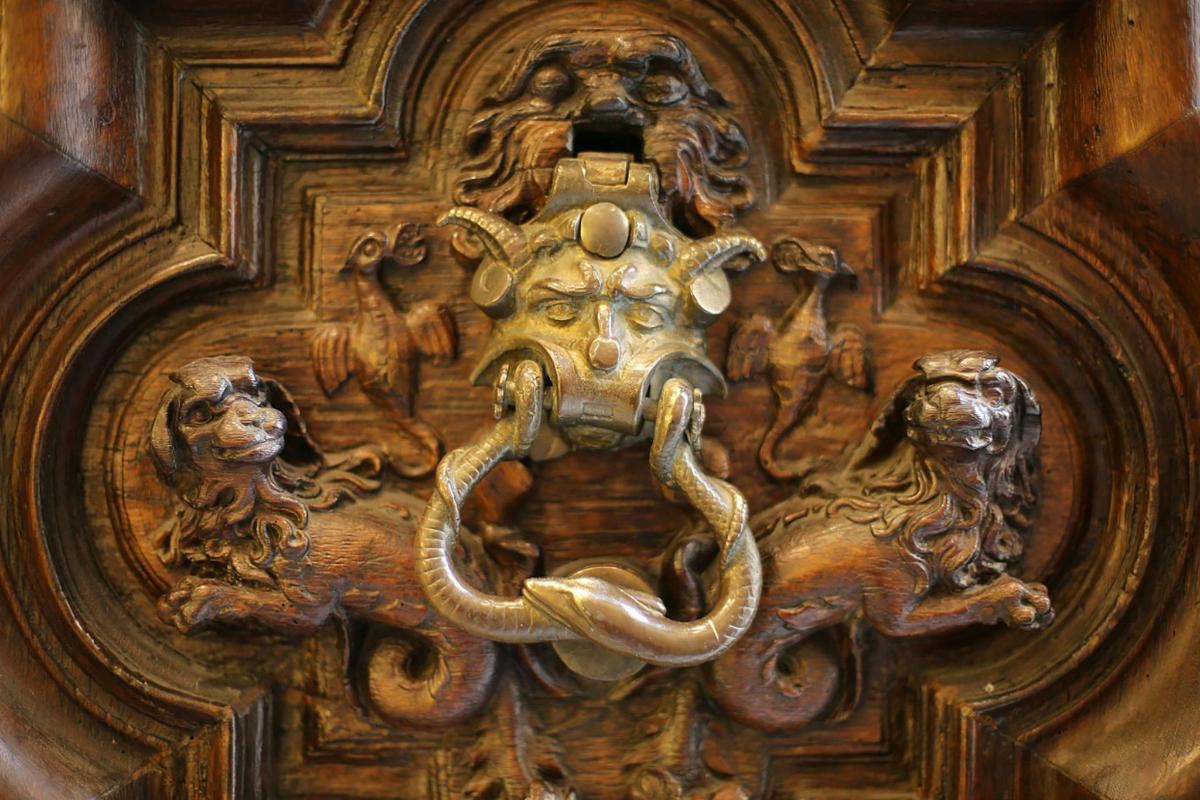 a wooden door with a carving of animals on it
