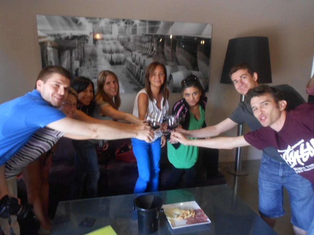 a group of people standing around a table holding hands