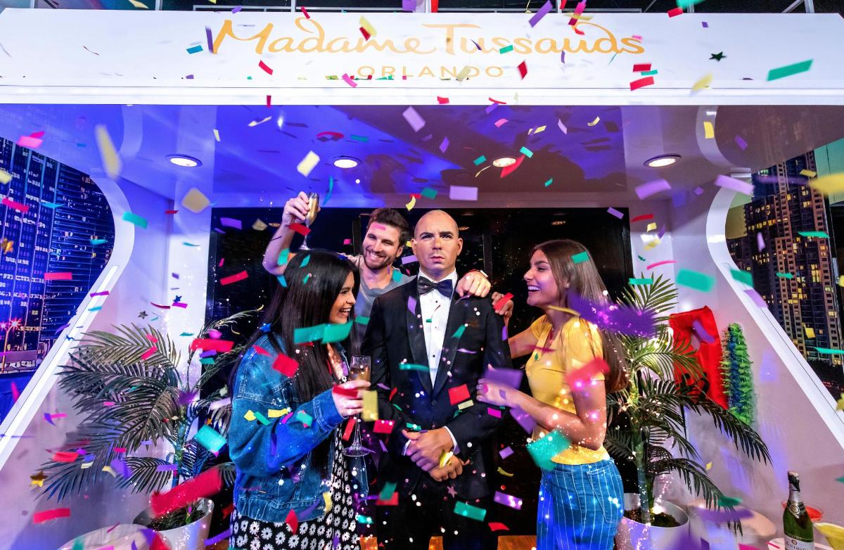 a group of people standing on a stage with confetti
