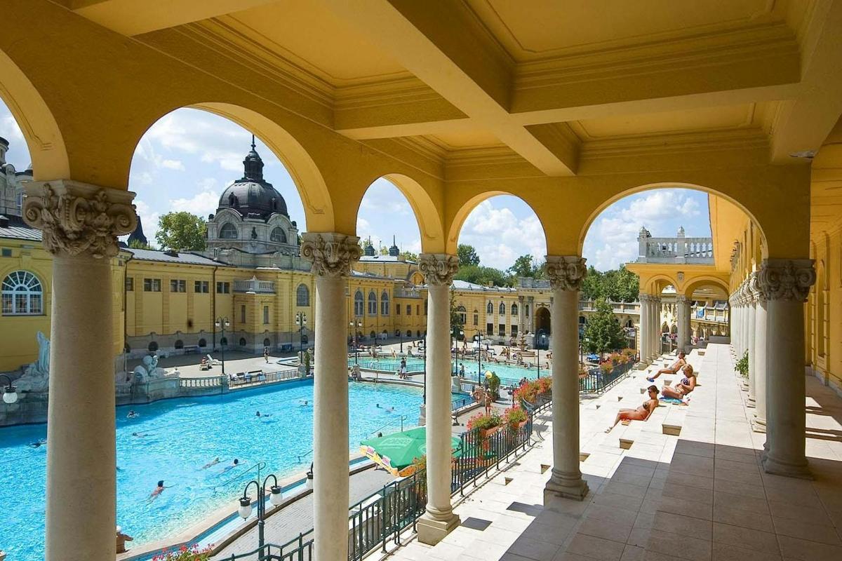 an indoor swimming pool in a building with columns