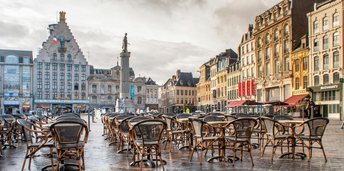 a row of chairs and tables on a city street
