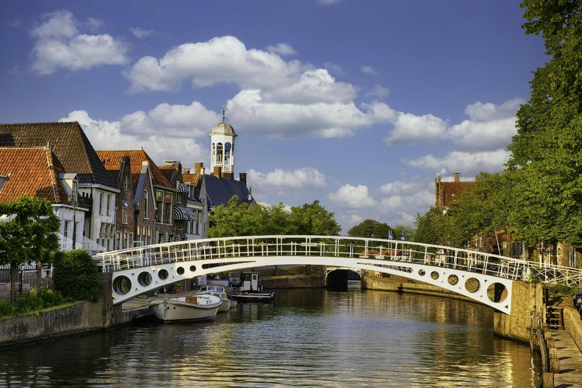 a bridge over a river in a city with buildings