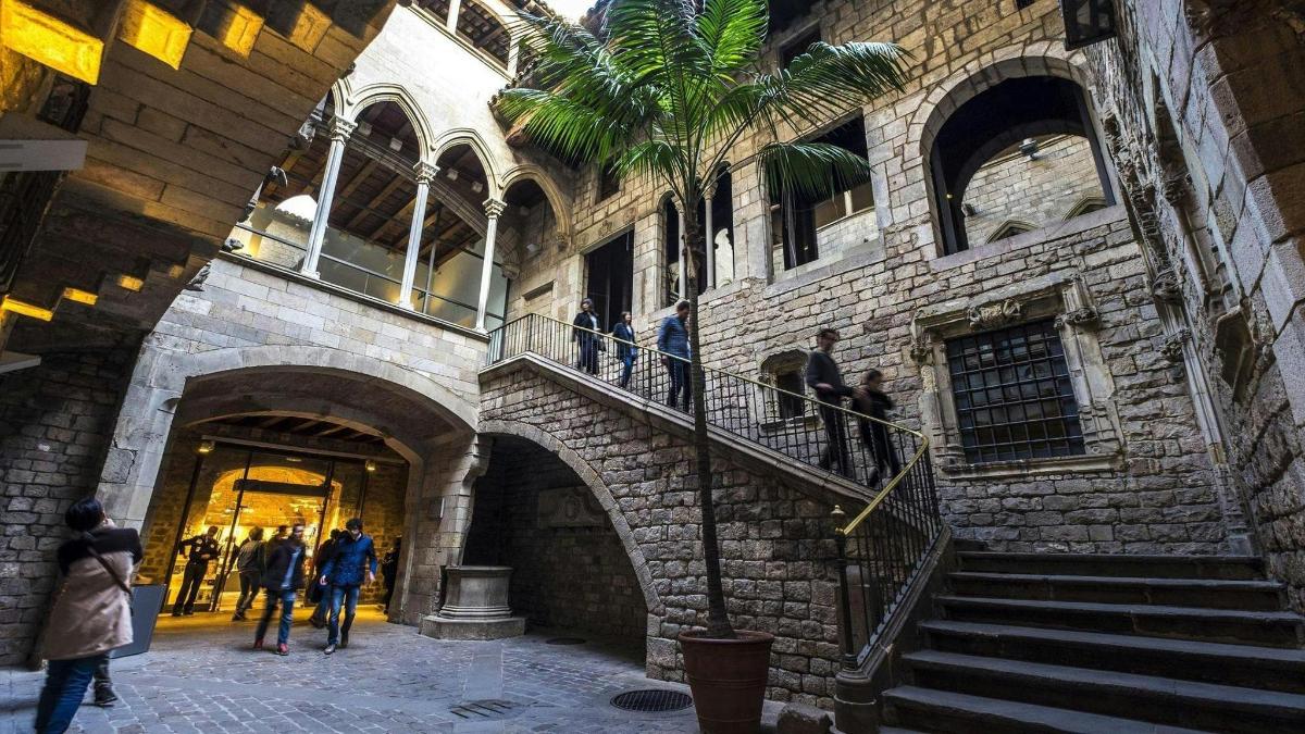 a group of people walking around a building