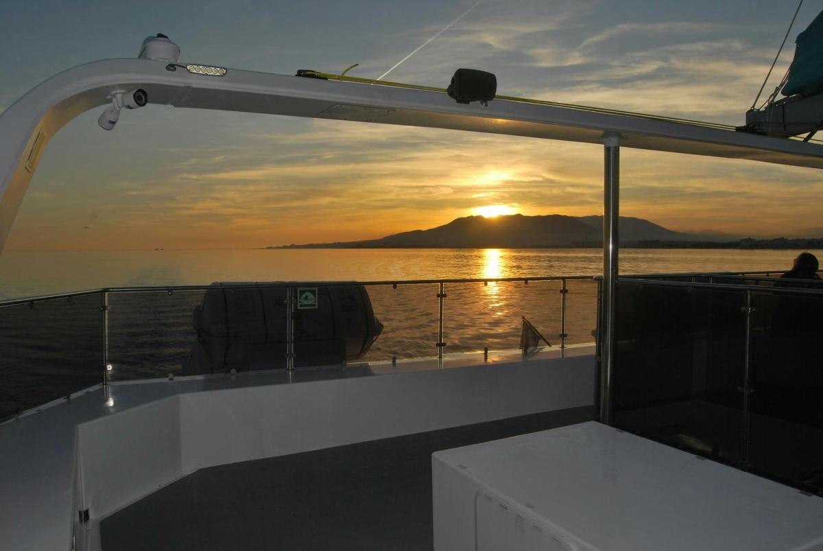 a view of the sunset from the deck of a boat