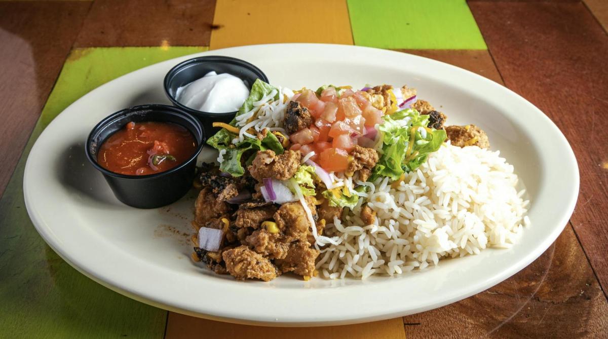 a plate of food with rice and meat and vegetables