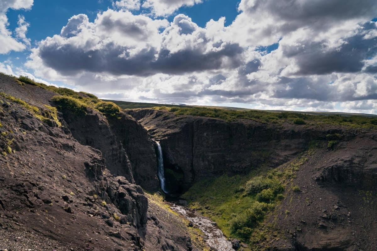 a waterfall on the side of a rocky cliff