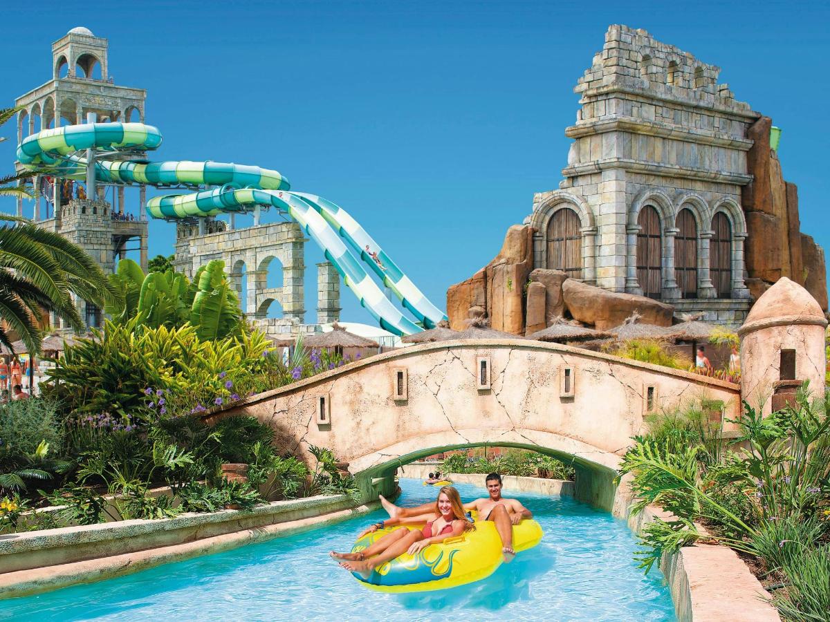 a group of people in a raft in the water at the theme park