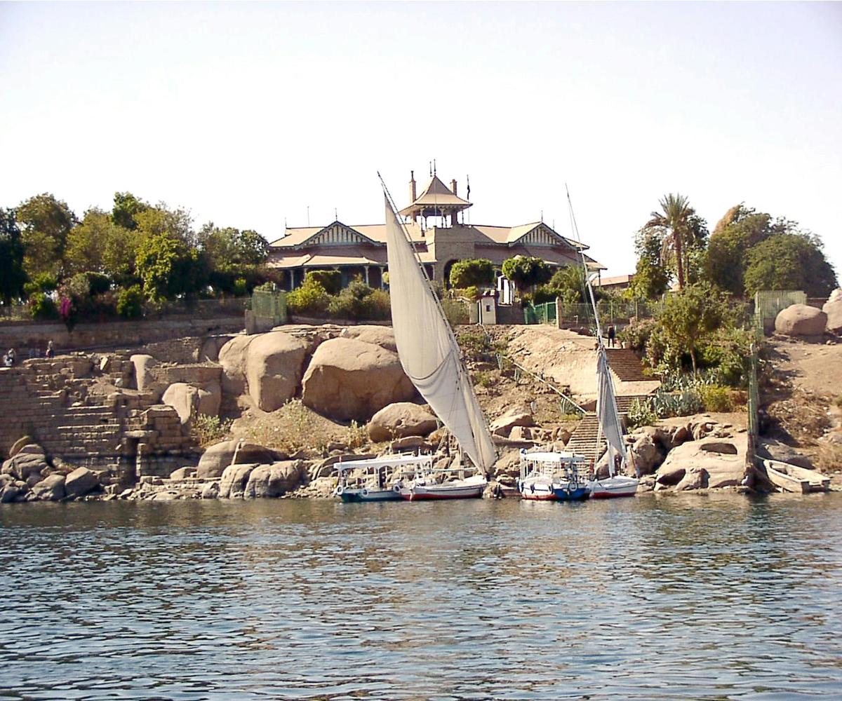 two sailboats are docked on a body of water